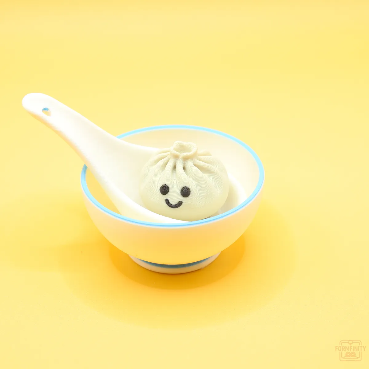 3D printed soup dumpling clicker fidget in a bowl with spoon