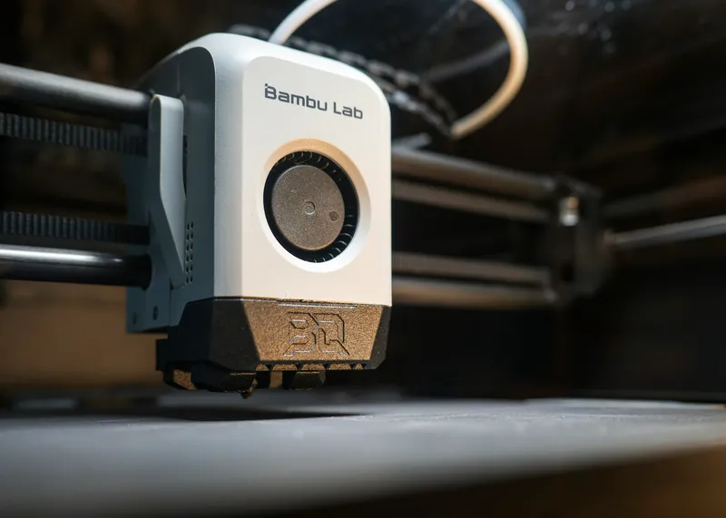Close-up of a Bambu Lab 3D printer toolhead inside the printer